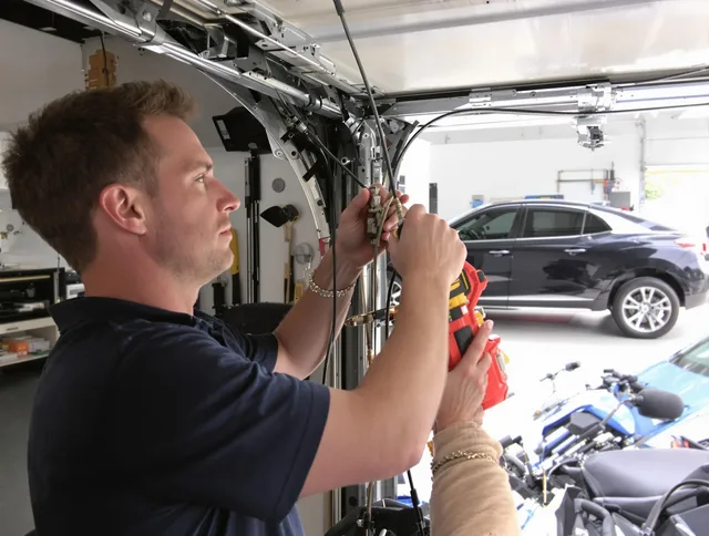 Parma Heights Garage Door Repair safety certified technician performing cable replacement in Parma Heights