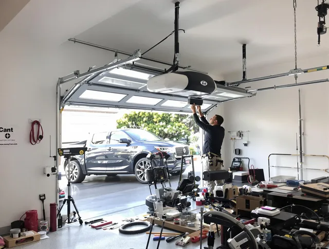 Parma Heights Garage Door Repair specialist installing smart garage door opener system in Parma Heights home